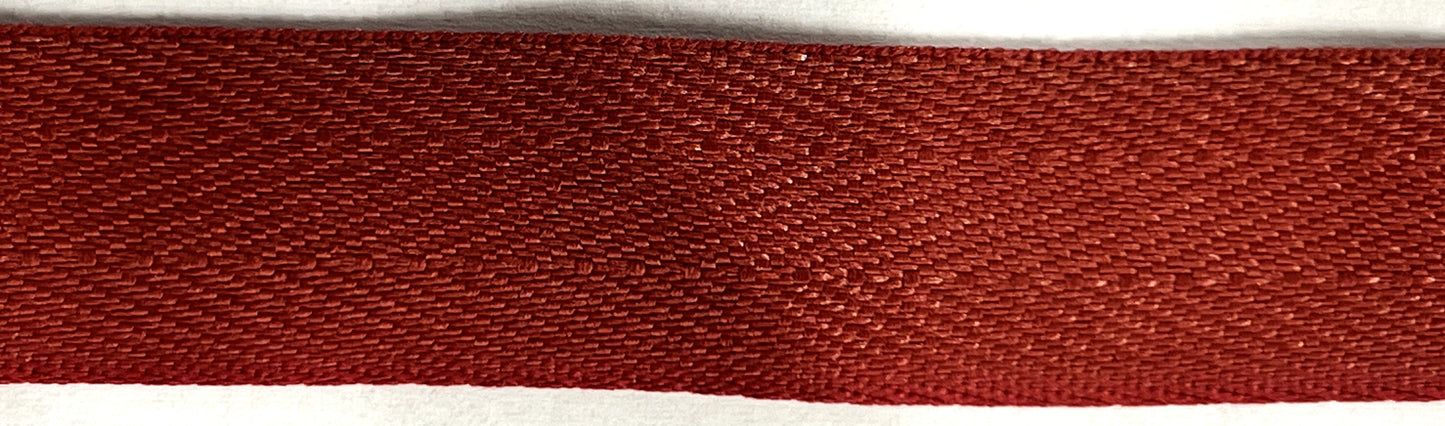 Close-up of a red woven fabric on a white background