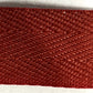 Close-up of a red woven fabric on a white background